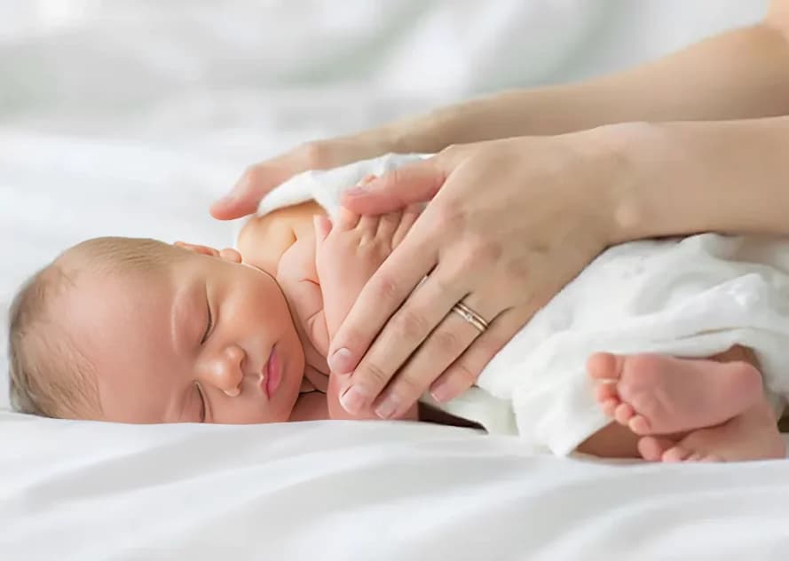 Professional caregiver gently holding and caring for a newborn baby