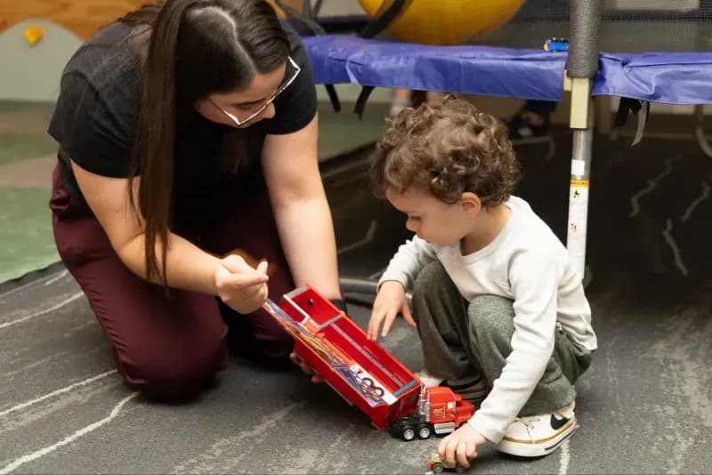 Therapist working with a child on developmental activities